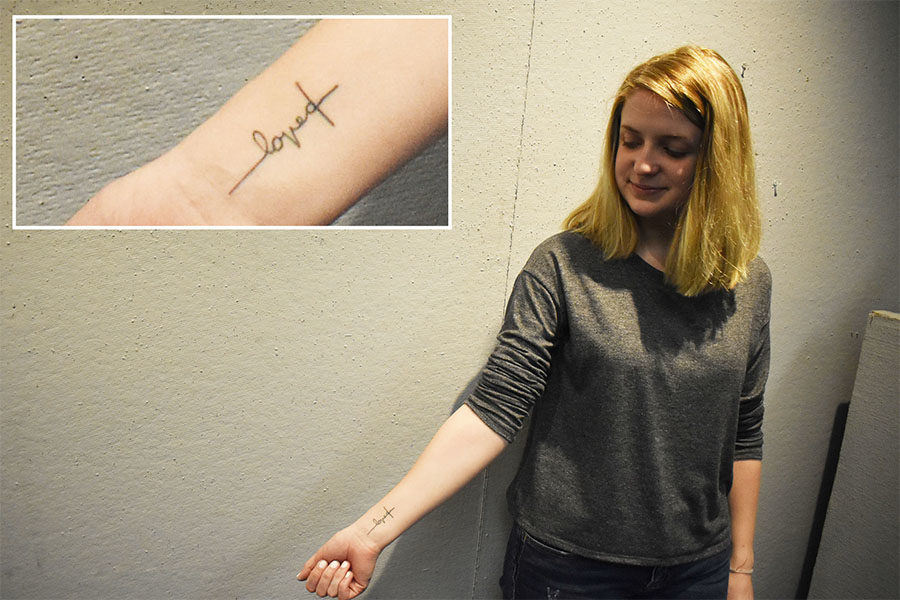 With the word “loved” made to look like a cross, senior Katharine Segrave exhibits her tattoo. Segrave faced hardships last year and relied on her faith to guide her through the adversity. “I shut everyone out of my life, and I felt like I didn’t have any hope. I wanted something permanent on my body to always remind me that regardless of what my mind might be thinking, I can’t wipe away the fact that He loves me,” Segrave said. “This tattoo means a connection to God that I can never take away because it is a permanent thing on my body, and it’s very special to me.” 