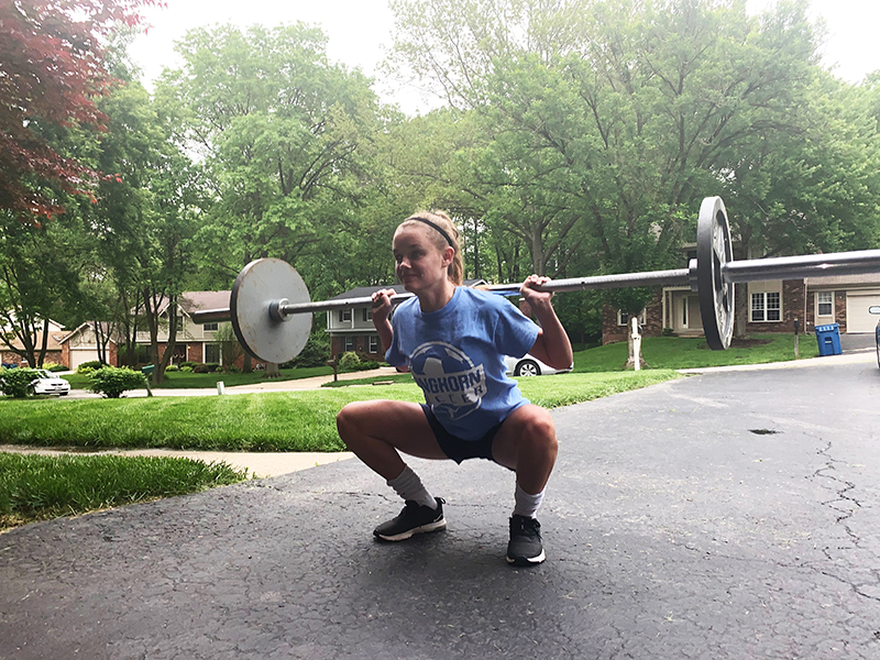 Sophomore Claire Hardy back squats 115 pounds. Claire has been weight lifting to get stronger for soccer and to stay in shape. “If you look back and your numbers are all the same, then you feel like you have done nothing, but it’s good to look back and see your improvements,” Hardy said.  