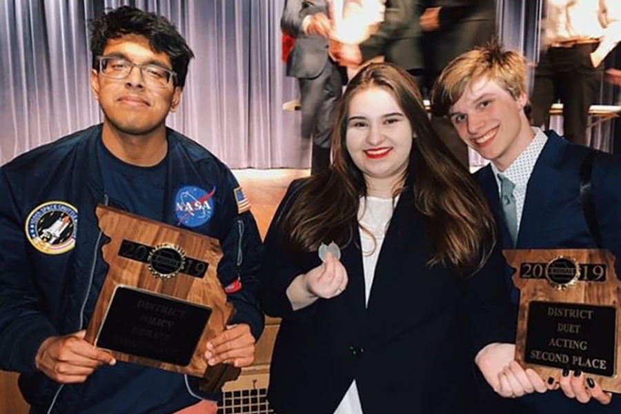 Seniors Gokul Venkatachalam, Kristina Humphrey and Luke Donovan pose with their plaques from the district tournament. Venkatachalam will go to nationals in the “Policy Debate” event and Humphrey and Donovan will compete in the “Duo Interpretation” event. “I’ve never been to the national tournament before,” Humphrey said. “I know it’s very competitive because you’re competing against a bunch of national qualifiers. I hope we can do well, and I doubt we’ll make the final stage, but we’re going to try as hard as we can.”