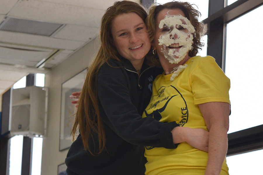 Covered+in+whipped+cream%2C+Spanish+teacher+Eileen+Kiser+hugs+sophomore+Zoe+DeYoung+in+the+cafeteria.+Kiser+braced+for+impact+before+DeYoung+pied+her+to+raise+money+for+Friends+of+Kids+with+Cancer.+%E2%80%9CMrs.+Kiser+and+I+have+a+really+close+relationship%2C+and+we+were+both+really+hoping+that+my+name+would+be+drawn+so+I+could+pie+her.+When+my+name+was+drawn%2C+we+immediately+looked+for+each+other%2C+and+we+were+so+surprised%2C%E2%80%9D+DeYoung+said.