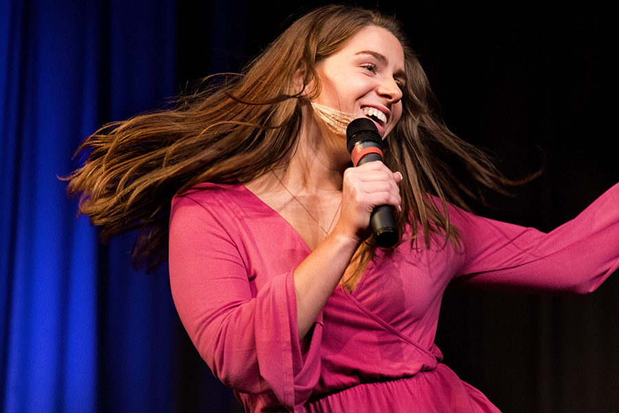 Performing Gloria Gaynor’s “I Will Survive” at Singer’s Choice May 7, senior Bella Meara smiles as she sings into the microphone. The performance Tuesday night was Meara’s final performance as a high school student. “Every day choir helps me sound so much better and wakes me up if I’m having a slow morning,” Meara said. “Performing is a skill everyone should have because it’s such a good way to express your thoughts and emotions. Everyone should try it at least once.”