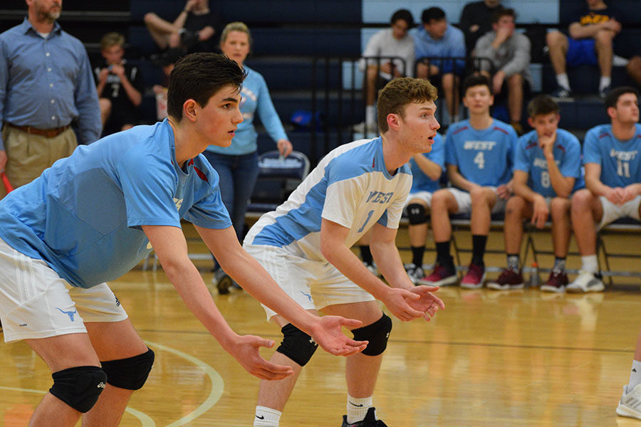 Sophomore Victor Ganev and senior Grant Young stand in a serve-receive position during a game against St. Louis University High School April 2. West lost 2-0, losing by only two points in the second set. “My favorite part about playing volleyball is serving or hitting because they are the only things that I can control. I can mentally prepare myself for my serve and focus on my hit so it goes where I want it to,” Ganev said. 