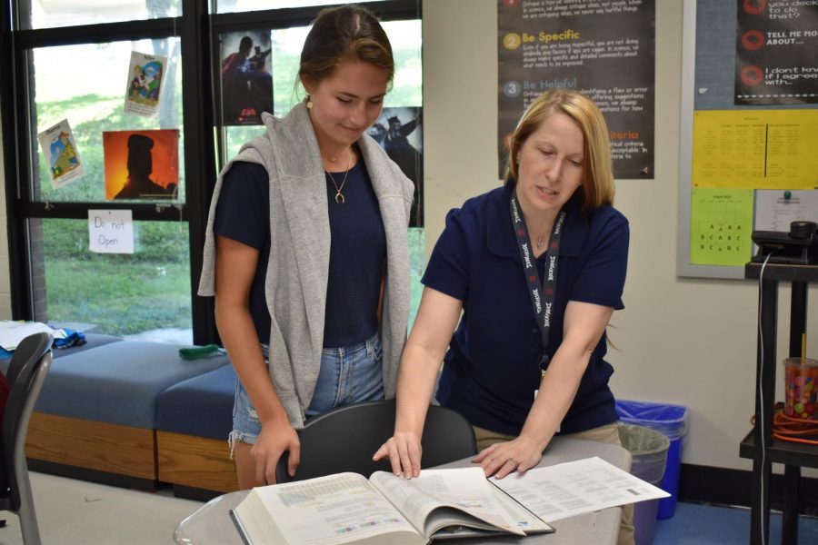 During a free period, new chemistry teacher Chloe Gallaher reviews basic chemistry information with senior Charlotte Zera. With a new school came new expectations and objectives for Gallaher’s classes. “[There are] increased lesson plans and things I’ll have to make for AP Chemistry,” Gallaher said. “For my freshman class, I’m trying to move towards a more personalized teaching style where they have some choices that will get them to the same end like they might rather do an online simulation versus an actual wet lab.”