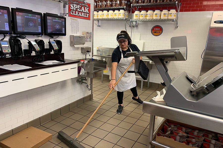 As her shift winds down, senior Umeera Farooq sweeps the floors of the kitchen at Jimmy John’s, a fast food sandwich chain. Having previously dealt with phone anxiety, stress resulting from having conversations over the phone, Farooq believes the laid back work environment helped her face her worries head on. “I have to socialize with people I don’t normally [socialize with] and just learn how to talk to people. This environment just forces me to talk on the phone,” Farooq said. “Even though I do not want to go into the food industry, the skills I’ve learned and will continue to learn are lifelong skills and will be super beneficial in all aspects going forward.”