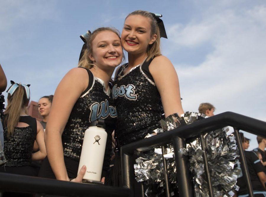 Fresh off their first performance at Red and Blue Night, freshman Kelsea Wilson hugs her sister, senior Kristin Wilson, excited that they completed their first routine together. Both tried out for poms and were excited to make varsity, it being the only year they will both be on the team. “My favorite part is the games, getting ready with her beforehand and having our parents get to watch us both perform,” Kristin said. 