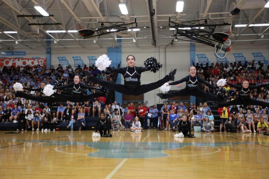 Leading the team, senior Poms captain Alexis Nadreau hits a toe touch. The seven minute dance took 18 hours to learn. “There was so much adrenaline, especially at the start of the routine. The whole school was cheering, and it was so hard to think straight because I was so focused on dance and the moves. It all went by so fast that when it was over I couldn’t even remember what I had just done,” Nadreau said.