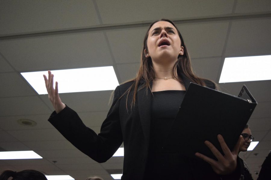 Before the first round of the tournament, junior Grace O’Connor rehearses her Program Oral Interpretation (POI) performance at the Randy Pierce Winter Classic at Pattonville High School Dec. 7, 2018. Competitors create a performance using various published works of prose, poetry and drama around a central theme. “It hurts when people dont listen to your piece because you spend so much time working on it, and you do really pour your heart into it,” O’Connor said. “When people dismiss it simply because of your gender, its so heartbreaking and for a lot of people its not worth it [to continue competing]. Its not worth the emotional labor and the aspects of just not being heard because of what you look like or what your gender is.”