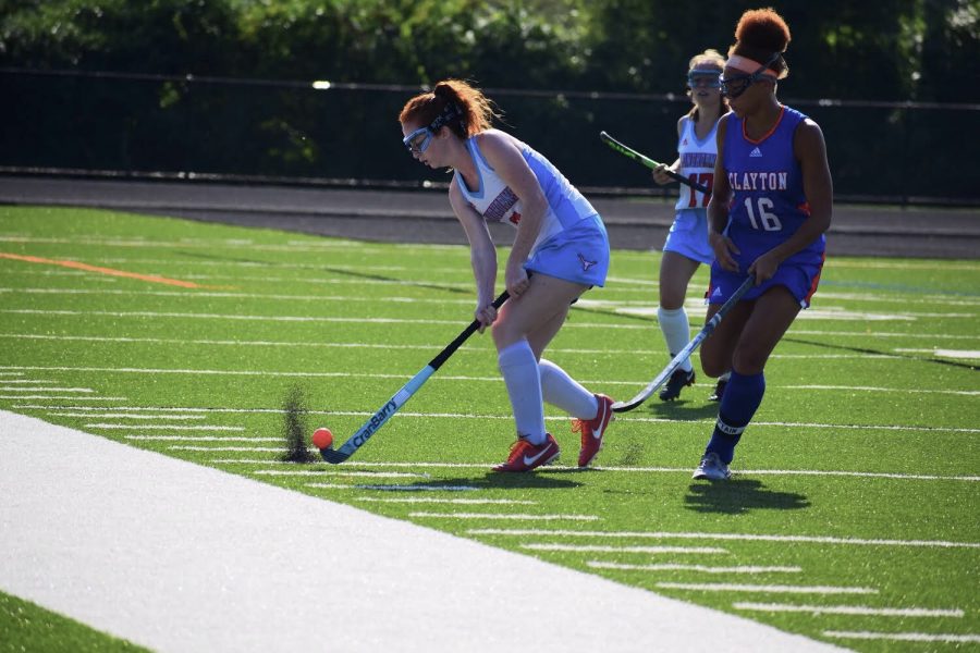 Making a pass down the field, senior and varsity midfielder Carly Anderson strikes the ball past a Clayton defender. Anderson has played varsity all four years of high school. I am really excited about this season, Anderson said. We started out a lot stronger than usual and were determined to finish out the season that same way.