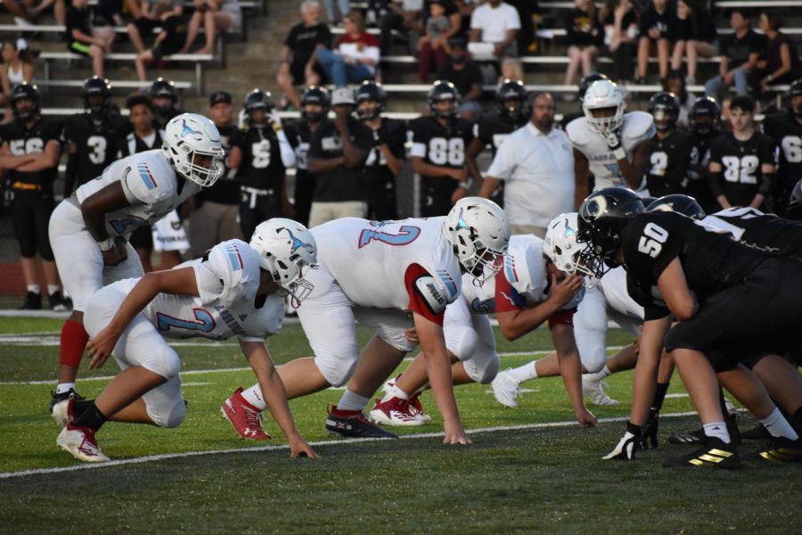 Set on the line of scrimmage, senior Chris Atkinson and his fellow Longhorns face off against Oakville Sept. 6. “Because we’re playing for the Mayor’s Cup and it’s our senior night, throughout practice we’ve been a lot more in it and focused,” Atkinson said. “We’re really confident for tonight, and on a scale of one to 10, we’re a nine. It's going to be a fun game, but it’s just sad that it’s senior night.”