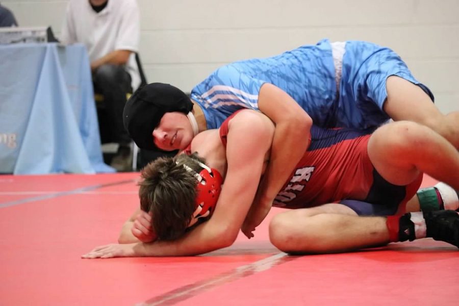 Senior Brayden Eddy pins down his opponent from Parkway South. Eddy wrestles year-round now that he has more time without football. “I don’t really feel anything during the match. It’s just me and the other guy wrestling,” Eddy said. “I try not to bring my emotions into my matches.” 