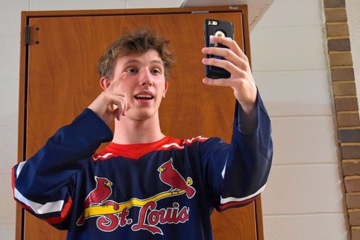 Standing in the hallways, sophomore Kyle Norman makes a Tik Tok video for his fans. Over the month of September, Norman gained over 2,000 fans on the app. “Sometimes, I feel like people don’t understand what I do or why I do [it] because I get weird looks when I make Tik Toks,” Norman said. “Nobody really thinks that it’s possible for just a normal guy like me to be so popular without showing it off to everybody.”
