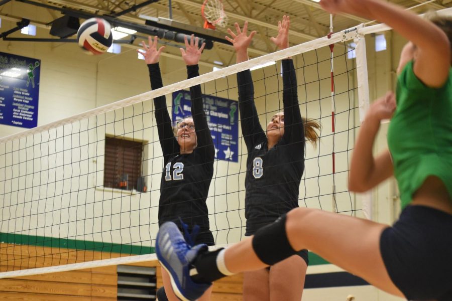 Blockers freshman Elise Frost and junior Carly Kuehl jump over the net to block the volleyball. Frost, having played since fifth grade, was the only freshman to make the varsity team. “I didn’t know what to expect [on varsity], but I quickly figured things out and don’t feel out of place or like a freshman; I just feel like another member of the team. This year was a lot of learning experience, and I liked the challenge of playing with people all older than me,” Frost said. “Volleyball taught me a lot about grit and never giving up when I want to accomplish something. I’ve learned when you take a risk and go for it, you can achieve anything. I couldn’t imagine life without it.”