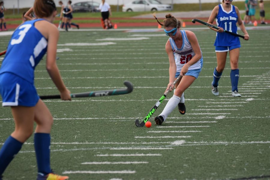Senior forward Callie Hummel dribbles with the ball on her stick, trying to advance or find an optimal passing location. The varsity team beat Notre Dame 4-1 September 25th, with Hummel scoring one of the four goals. [My favorite part about field hockey] is trying something new and going into something blindly but really enjoying it,” Hummel said.