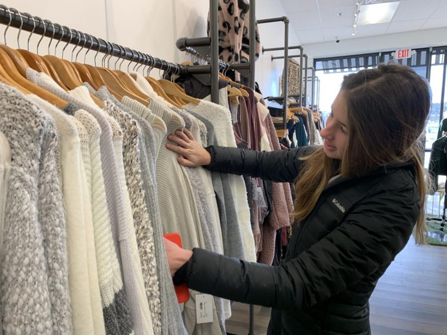 Browsing through racks, LOCO senior class representative Emily Lofgren shops for a new sweater at Mod On Trend. Lofgren helped organize the fundraiser and spread the word on social media. “I was so excited to hear that LOCO was holding a fundraiser with Mod,” Lofgren said. “I get to shop at one of my favorite stores while also contributing to an amazing cause.”