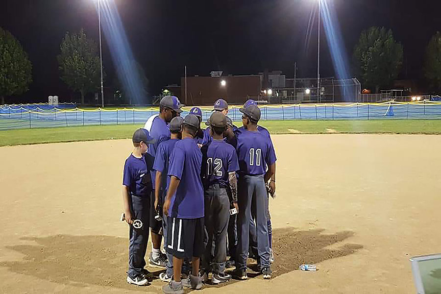 Youth+baseball+coach+and+alumni+Sherron+Rives+tells+his+players+the+long+season+is+not+over+yet+after+winning+first+place+in+a+spring+tournament.+Rives+led+his+14+and+under+team+to+three+tournament+wins+in+2018.+%E2%80%9CIt+was+really+different+to+play+for+him%2C%E2%80%9D+sophomore+Nathan+Basler+said.+%E2%80%9CHe+had+a+different+passion+for+the+game%2C+and+you+could+see+it+in+his+eyes+when+he+was+coaching.+He+loves+baseball+more+than+anyone+I%E2%80%99ve+seen+before.%E2%80%9D