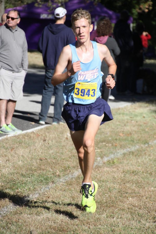 Sophomore Ben Taylor prepares to cross the finish line at a cross country meet.