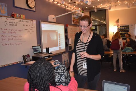 American Sign Language (ASL) teacher Jessie Menchak helps freshman Jaquenette Wheatley with her project on a famous deaf person in 6th hour ASL II class. The presentation will be given throughout the week in class to show famous figures in the deaf community. “I try to impact students by letting them know theyre in a safe space [and] that they can be comfortable here with the knowledge Im on their team,” Menchak said.