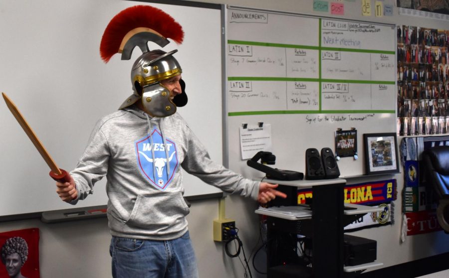 Latin teacher Tom Herpel entertains students with a sword and a gladiator helmet. In class, Herpel focused on the learning process while making the class enjoyable for students and involving cultural experiences. “I’ll always remember the vocative tense, or command tense, because we learned it and vocab by doing yoga-like the game Twister,” Rutledge said. 