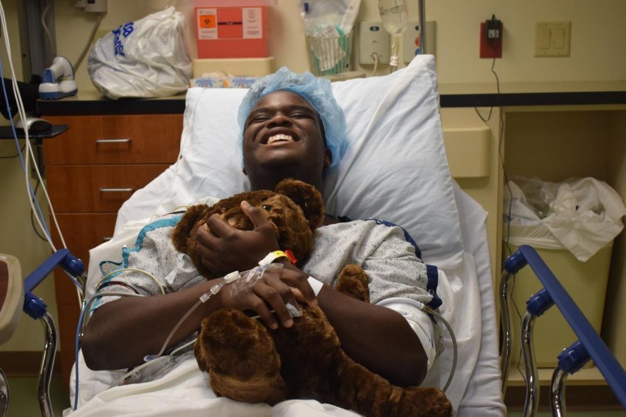 Smiling before surgery, junior Tim Nelson holds a teddy bear. Nelson was excited to undergo surgery so that he could begin the long recovery process. “After the pain goes away, I know [the  recovery process] will be easy,” Nelson said. “I just need to have patience, and thats kind of something I dont have all the time.”