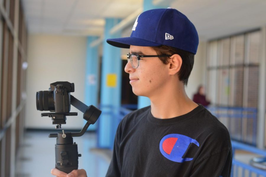 Senior Ismail Hacking focuses his camera using his stabilizer. Hacking has invested in high grade video equipment to better the quality of his videos. “Video is unlike any other art form in the way that it combines visuals with audio to create something that speaks to people,” Hacking said.