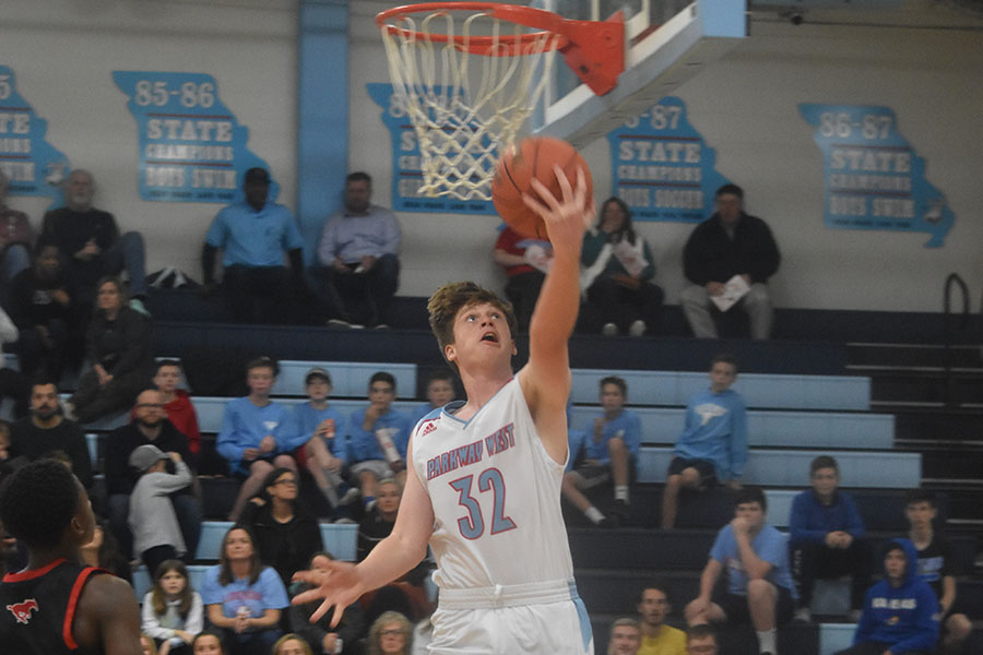 Finishing the layup, sophomore Luke Wright scores another basket in his first career varsity start. Wright went one of four shooting in the season opener. “I was really proud to be a starter but I know I could’ve played better that game,” Wright said. “Im ready to see where this season can go.”