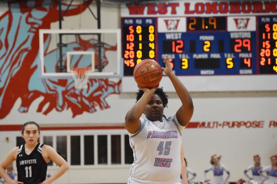 Shooting a free throw, senior Tia Reed plays basketball against Lafayette High School Jan. 7. With a final score of 32-59, Reed and her team had to adapt to sudden changes before the game. “I was feeling frustrated during this game because one of my teammates wasn’t playing because she was hurt, so I had to step up, and the freshman had to step up. We were all playing different positions [than usual],” Reed said. “My teammates and the fun team environment keep me motivated.”