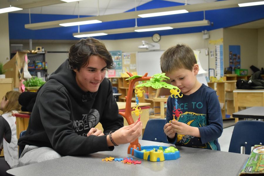 Balancing monkeys on a tree, senior Fernando Gonzalez participates in a Beta Omicron Kappa (BOK) volunteering opportunity at the Early Childhood Center. BOK members went to the Early Childhood Center once every month to play with and read to the children. “I enjoyed going and watching the kids’ faces light up when we played with them while they waited for their parents,” Gonzalez said. “The little boy was a lot better at balancing the monkeys than I was, as you can see with my intense focus and his calm demeanor.”