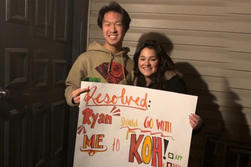 Freshmen Ryan Feng and Hope Green smile with the KOH poster Green made.