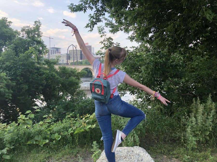 Hitting a posse, senior Maggie Lyerla balances on a rock in front of a river in St. Paul, MN. Lyerla explored St. Paul, Minn. while she was recovering at The Emily Program in July. “It was cool to travel somewhere I’ve never been, even though it wasn’t necessarily a vacation,” Lyerla said.