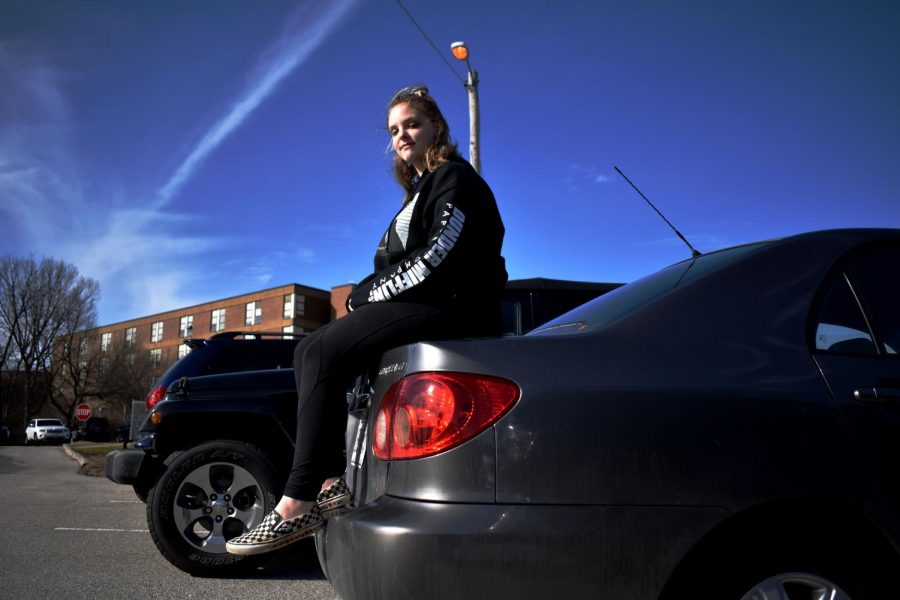 Junior Michaela Linden sits on the trunk of her car. She now has her license, but there were a few instances in the weeks following the accident that Michaela needed to walk home. “The rest of last year I walked home a total of three times after I got hit, and every time I had a panic attack,” Michaela said. “It was very soon after [the accident] and I was still very on edge about it. I got rides from friends when I could, or I had parents pick me up.” 