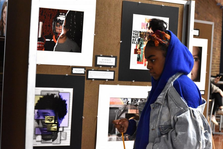 Searching for the piece of art that she will respond to, Creative Writing student and senior Allainah Crawford looks at works from the AP Design and Photography class. “This project is ‘free range’ compared to some of the other ones,” English teacher Dan Barnes said. “With express the music, we have word count, [but] with this one, I just want my students to be inspired by art.”