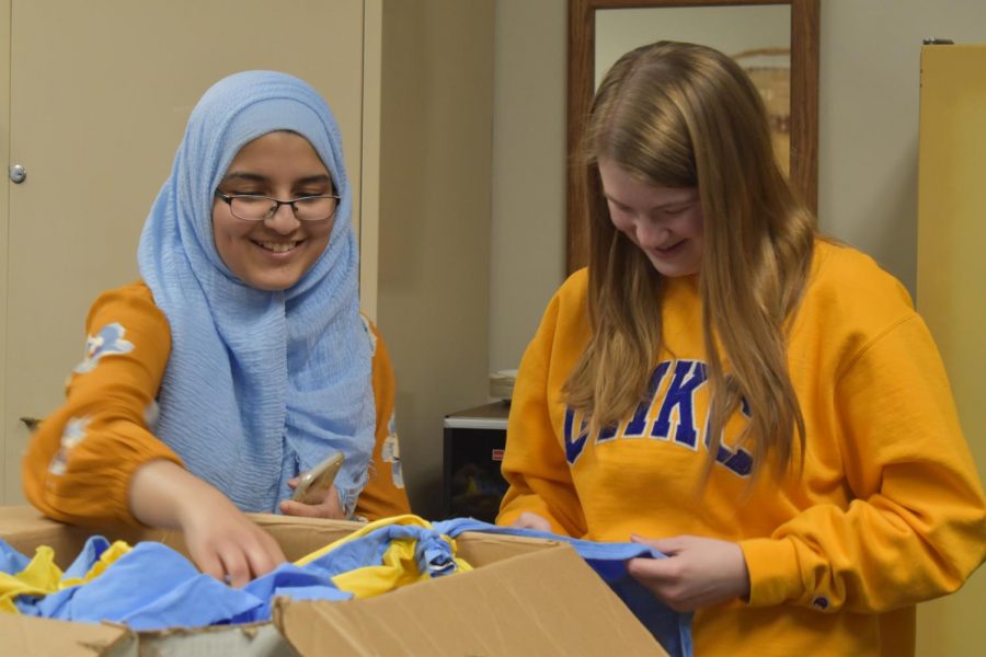 Cutting+out+strips+of+fabric+for+a+Day+of+Service+freshmen+project%2C+junior+and+club-founder+Fatima+Shahab+and+junior+Brooke+Gangel+construct+dog+toys+to+be+donated+to+the+Humane+Society.+Crafting+for+a+Cause+meets+once+a+month+to+focus+on+a+new+project+and+create+hand-made+items+to+donate+to+different+organizations.+%E2%80%9CThe+goal+is+to+make+something+or+have+some+sort+of+project+to+donate+or+help+someone+in+some+way%2C%E2%80%9D+Shahab+said.+%E2%80%9CI+decided+to+start+Crafting+for+a+Cause+because+I+really+like+crafting+and+sewing.+I+wanted+to+combine+my+hobby+with+helping+others+and+I+thought+this+was+a+good+way+to+do+that.%E2%80%9D