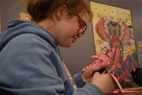 Taking advantage of ASL Club time after school in ASL Club Sponsor Jessie Menchak’s room, freshman and ASL Club member Bella Neisius cuts out hand-shaped Valentines. Club members gathered together to cut out cards and make tissue paper flowers for Valentines. “I like learning new things about the Deaf community at West and [meeting] all the Deaf kids within [our school] and connecting with them,” Neisius said.  