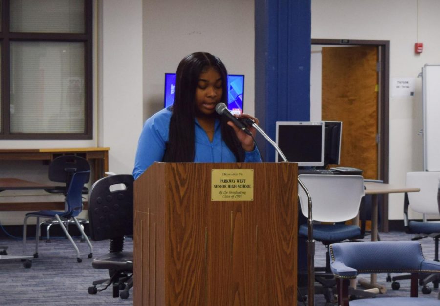 Performing an original piece, senior Taylor Fischer raps for students attending the African American Read-In in the library.