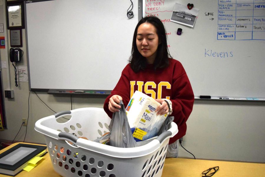 Senior Nayeon Ryu organizes a bin of donations. Donations were dropped off starting Jan. 21. “This is an important issue we are tackling because it isn’t normally talked about in high school,” Ryu said. “This is because many of us are privileged enough to have easy access to these products.”