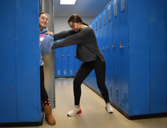 Junior Ima Dropout tries to escape as senior Betsy Class tries to put her into a locker. Since joining the school last year, Dropout has faced adversity with honors students bullying. “When I first came here I was hoping it would be a little different from [Parkway] South. Turns out I was so unbelievably wrong,” Dropout said. “Everyone at this school is way bigger, stronger and smarter than back at my old school, and it honestly scares me.”