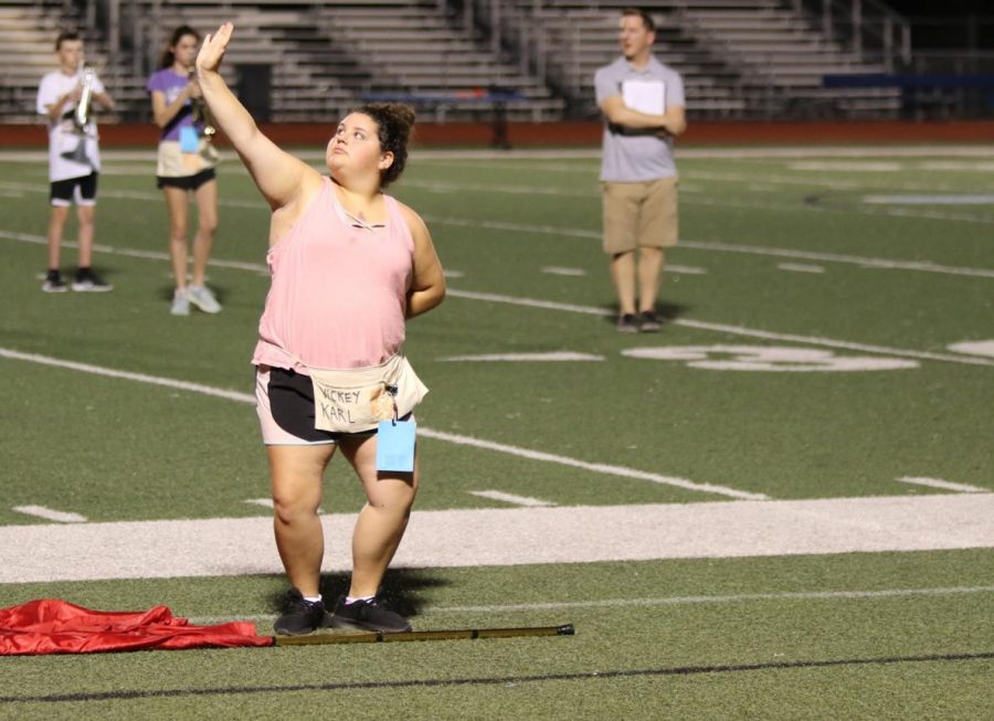 Senior Vickey Karl practices her dance on the turf before the upcoming show “Hejira a Desert Diary.” The performance was held at Fox High School during their preliminary competition Sept. 28. “I am very glad that the whole process went well. I feel much better mentally, and I am also physically improving as well,” Karl said. “I am excited to now be a part of color guard, and I am glad that the whole thing is over. Now, I can just enjoy myself without having to worry about my health.”