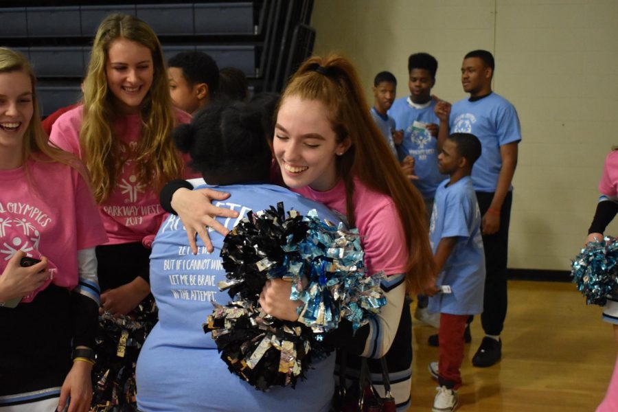 Junior and cheerleader Tori Fischer hugs a Special Olympics athlete during the opening ceremony last year. Throughout the basketball tournament, cheerleaders encourage athletes from the side of the court. “Cheering for Special Olympics is honestly one of my favorite things I get to do during the school year,” Fischer said. “At normal games, we have to stay in formations and do planned cheers and people are so used to us that [it] doesnt get people excited. But at Special Olympics a lot of the athletes get excited when they hear us cheering for them and we can cheer them on in a totally relaxed and more personal way.”