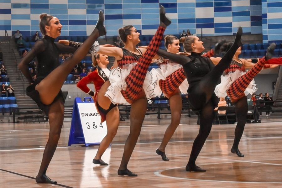 Dressed in costumes inspired by “The Greatest Showman,” junior Emma Roth, freshman Audrey Griswold and senior Kalina Kellogg kick to the song, “The Greatest Show.” Poms placed fourth in Division Four Kick at the Missouri Dance Team Association state competition Feb. 29. “We all dug deep and gave our all because we wanted to make the seniors’ last dance memorable. I think that we performed better than we ever have,” Roth said. “I’m sad that the season is over, but I’m glad that I could make lasting memories with the team for the last time.”