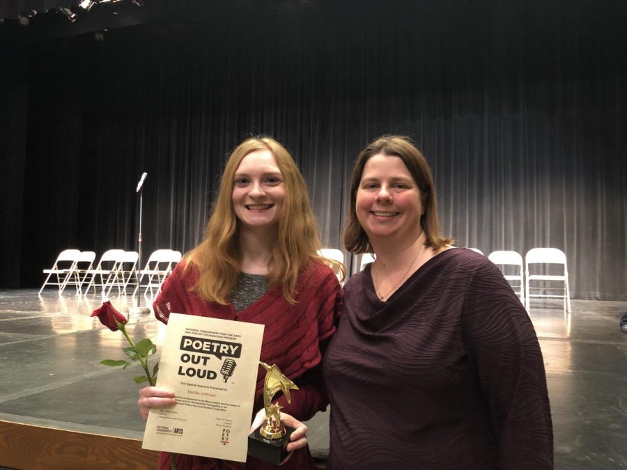 Senior Maddie Hoffmann celebrates her success at the 2020 Poetry Out Loud regional competition with English teacher Andrea Benmuvhar. Hoffmann received a certificate and a trophy as well as a flower for her achievement. “I never thought that I’d go up on stage and force myself [to perform], but I think I took my confidence a step further. I’m very proud of what I’m now capable of doing. I’m glad that I overcame my stage fright as well as testing out my knowledge on poetry,” Hoffmann said.