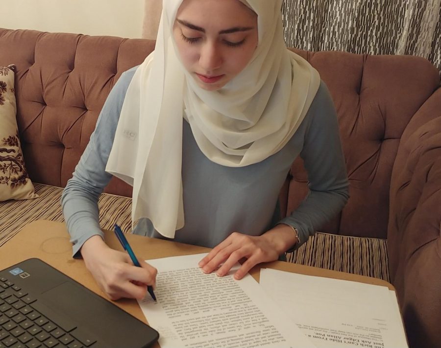 Annotating her copy of the short story, sophomore Zeina Daboul works on her assignment. Daboul found the parallels between the story and modern times interesting. “When you look deeper [into the story], you can see that it reflects our society, in ways that you wouldnt think a story written in 1842 would,” Daboul said. 