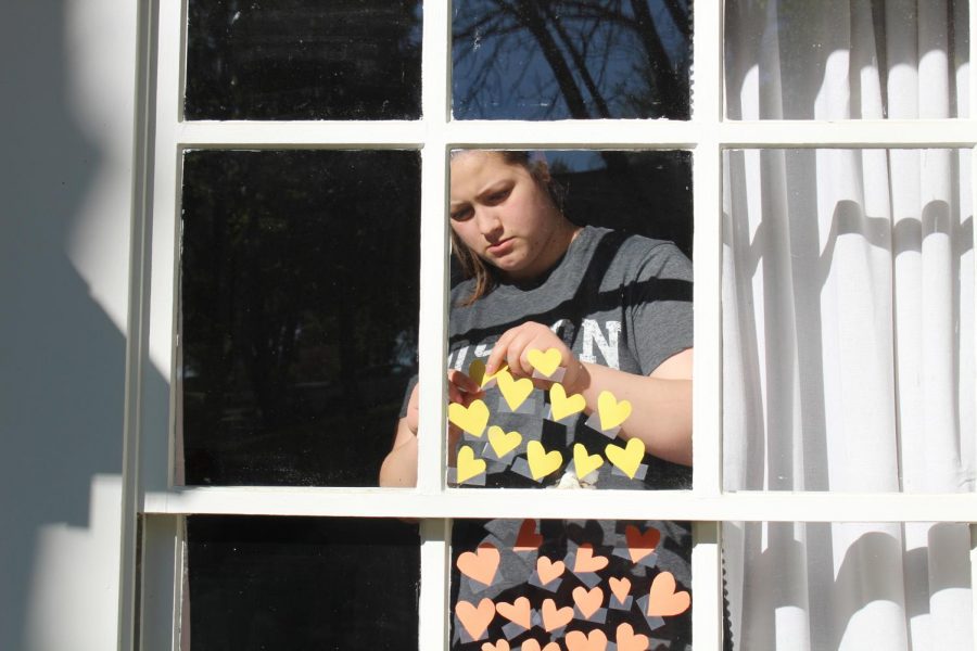 Sister of senior Madi Foppe, Kennedy Foppe, tapes paper hearts to her window to form a rainbow of hearts. She came up with the idea after seeing people share rainbows and wanted to incorporate hearts to represent love and kindness for healthcare and essential workers. “We enjoy [art] but we don’t get to do it a lot. During quarantine we have definitely gotten to do more,” M. Foppe said. “We had an idea to create a rainbow of hope out of hearts to spread hope and love during these uncertain times.”
