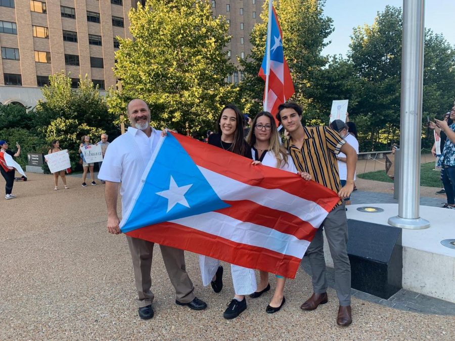 Holding the Puerto Rican flag,  Gonzalez and his parents attend an event in downtown St. Louis with other Puerto Ricans that live in the area.