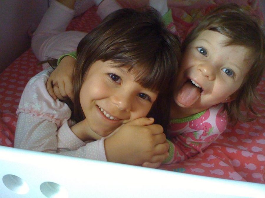 In her house in Jundiai, Brazil, D’Aquino Lazarini poses with her sister, Clara, at age seven. 

