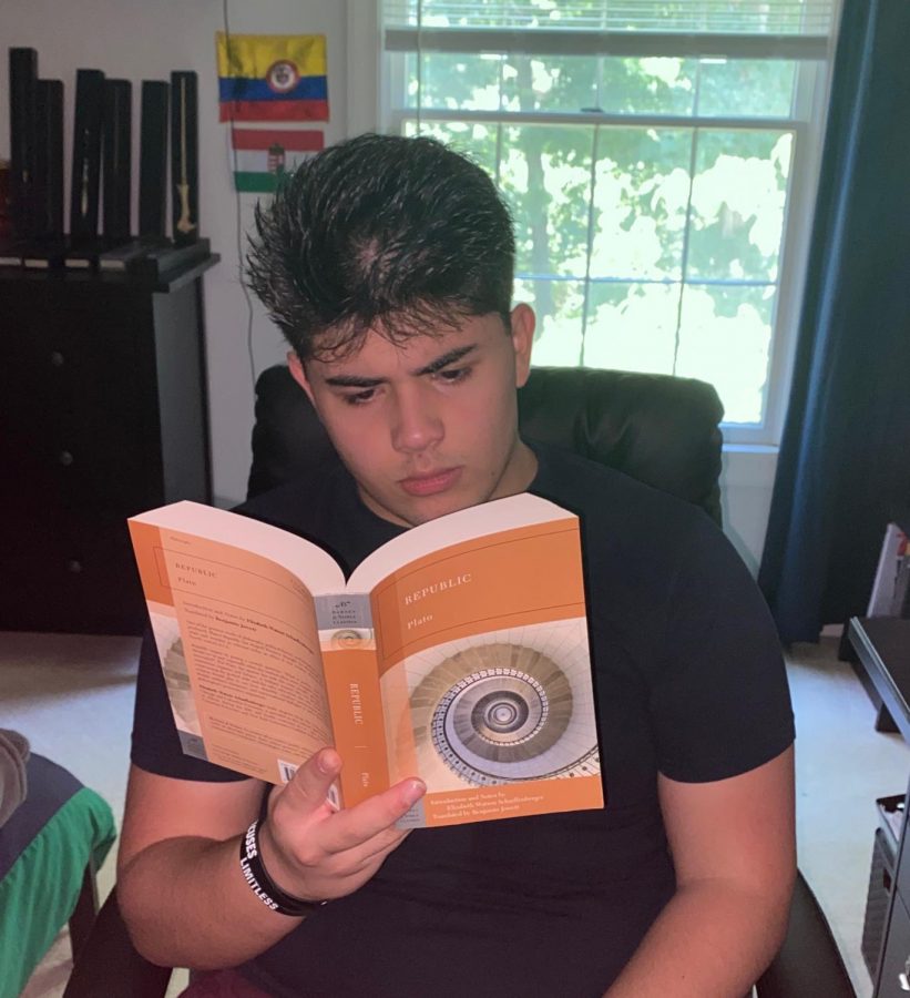Reading a book, junior Santi Lugo strives to reach his reading goals. 