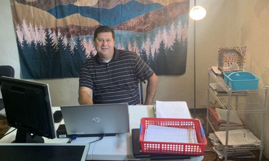 Showing off his setup, social studies teacher John Wright has gotten comfortable in his new classroom. Before the school year, everyone in the Wright family had to arrange and organize their own learning space. “We basically broke it up into districts,” J. Wright said. “And so far everything has worked great, hopefully it can stay that way.”