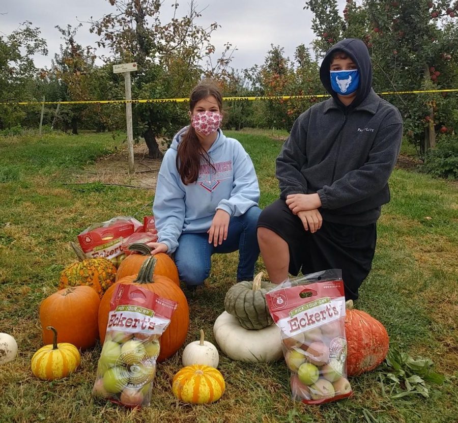 Picking apples with the family, freshman Presley George and her brother Henry George enjoy a day at Eckert's Farm. Going pumpkin picking is a great way to celebrate Halloween, and P. George and her family were able to have a safe, healthy day. "The pumpkin patch and apple orchard at Eckert's Grafton Farm are spread out, and you could do both things while distancing. The closest you get to others is when you are on the wagon ride, but if you are just a few people on the wagon, you should be able to social distance safely, and have fun," P. George said.