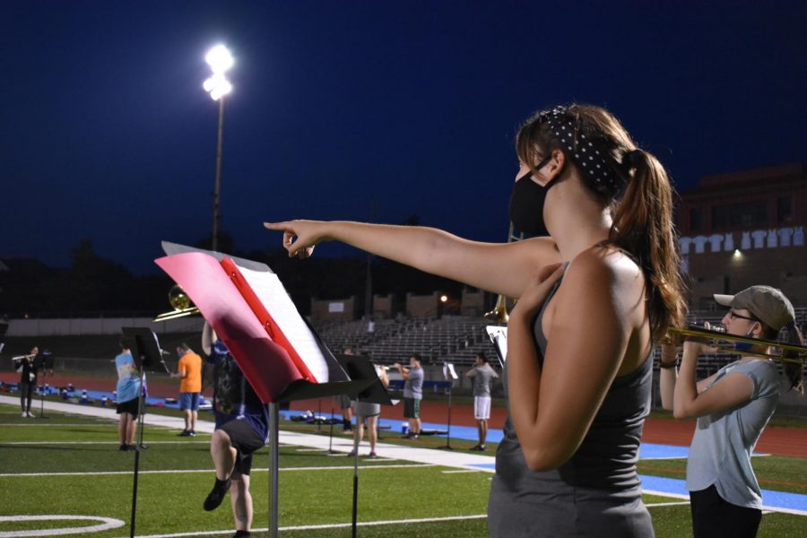 Senior section leader Abbey Thompson directs the low brass at practice. She remains socially distant and masked. “I always struggled to find motivation to get into a practice routine but with all the extra time with quarantine I was able to dedicate real time to practice. I saw a pretty big improvement not only in my sound but also my confidence as a musician,” Thompson said.