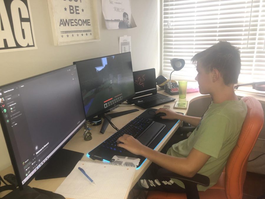 Freshman Eli Fassler plays minecraft after finishing his virtual school day
