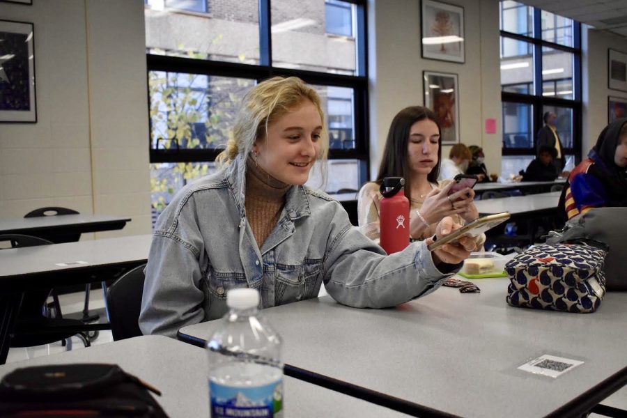 Sitting down for lunch, sophomore Cece Watts scans the cafeteria QR code. Watts attended school in person for the first time since March 13. Being back in person felt amazing, Watts said. The set up for lunch allowed me to easily and safely congregate with my friends while still maintaining a respectful distance.